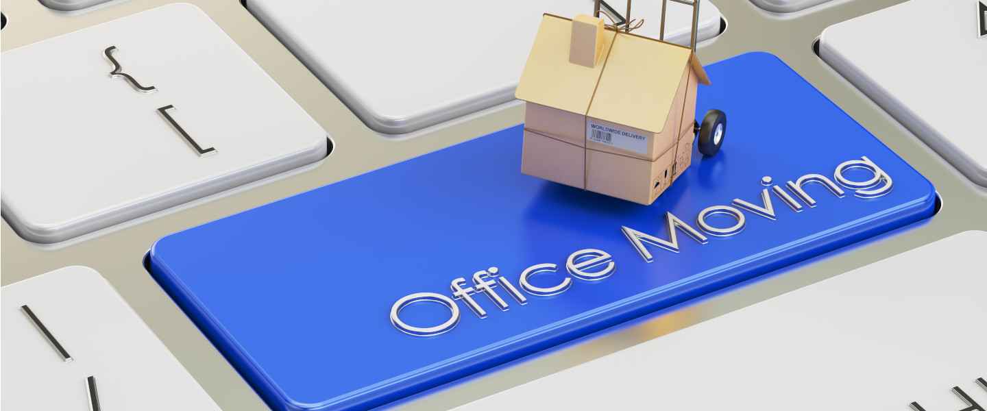 Miniature house on keyboard key labeled office moving